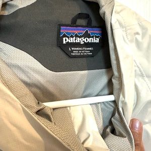 White Patagonia W Torrentshell rain jacket - has a yellow stain on front